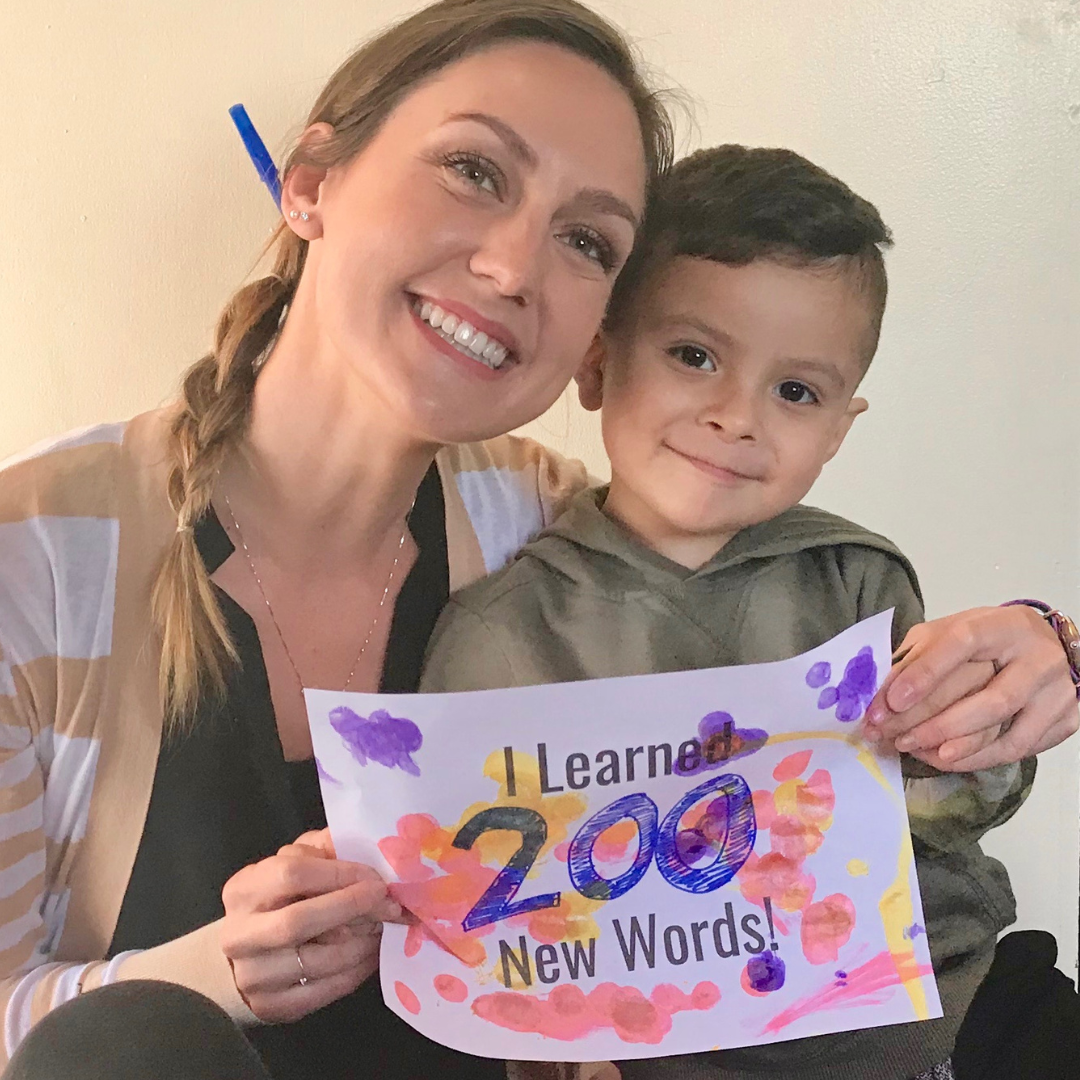 kayla and child holding a sign