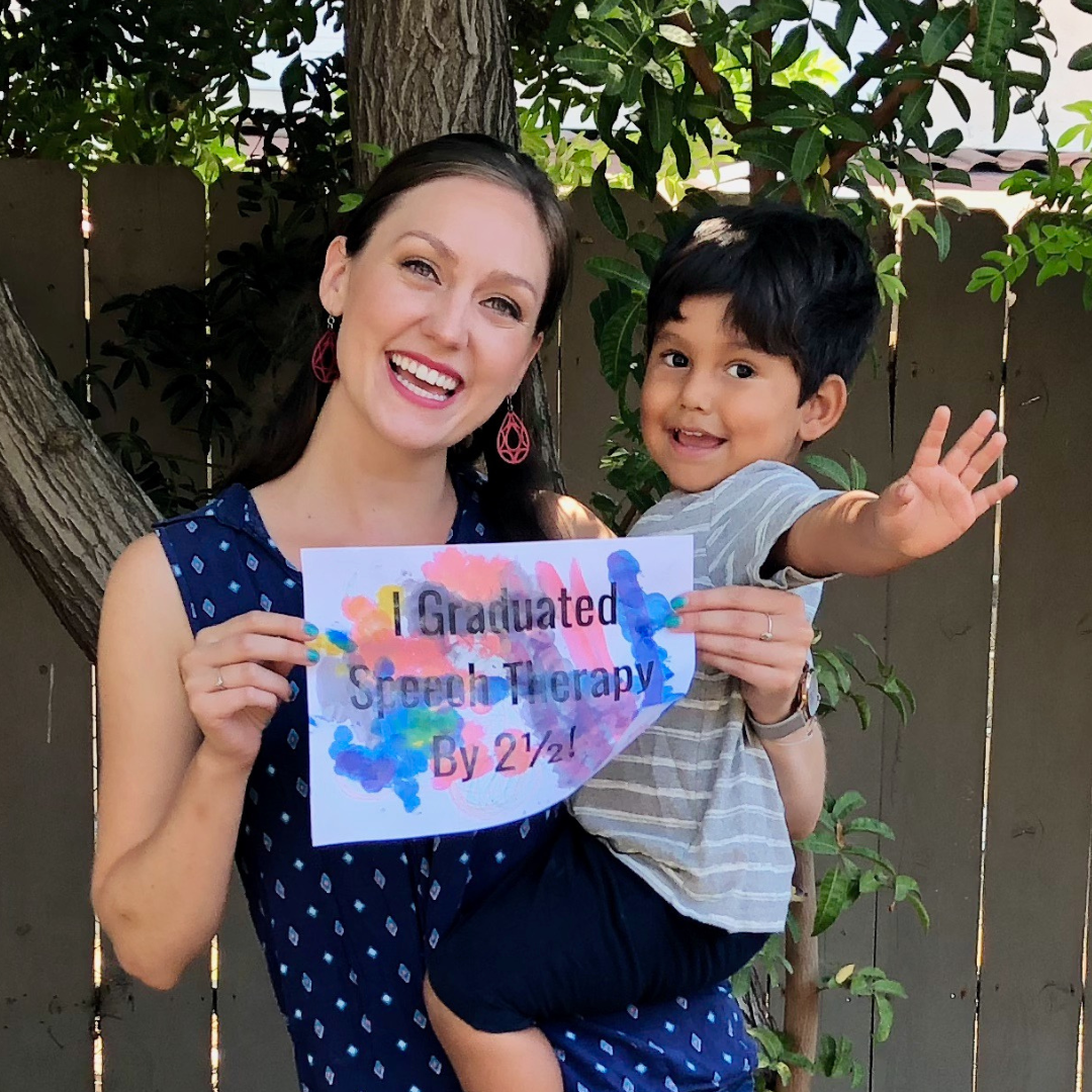kayla holding child and sign